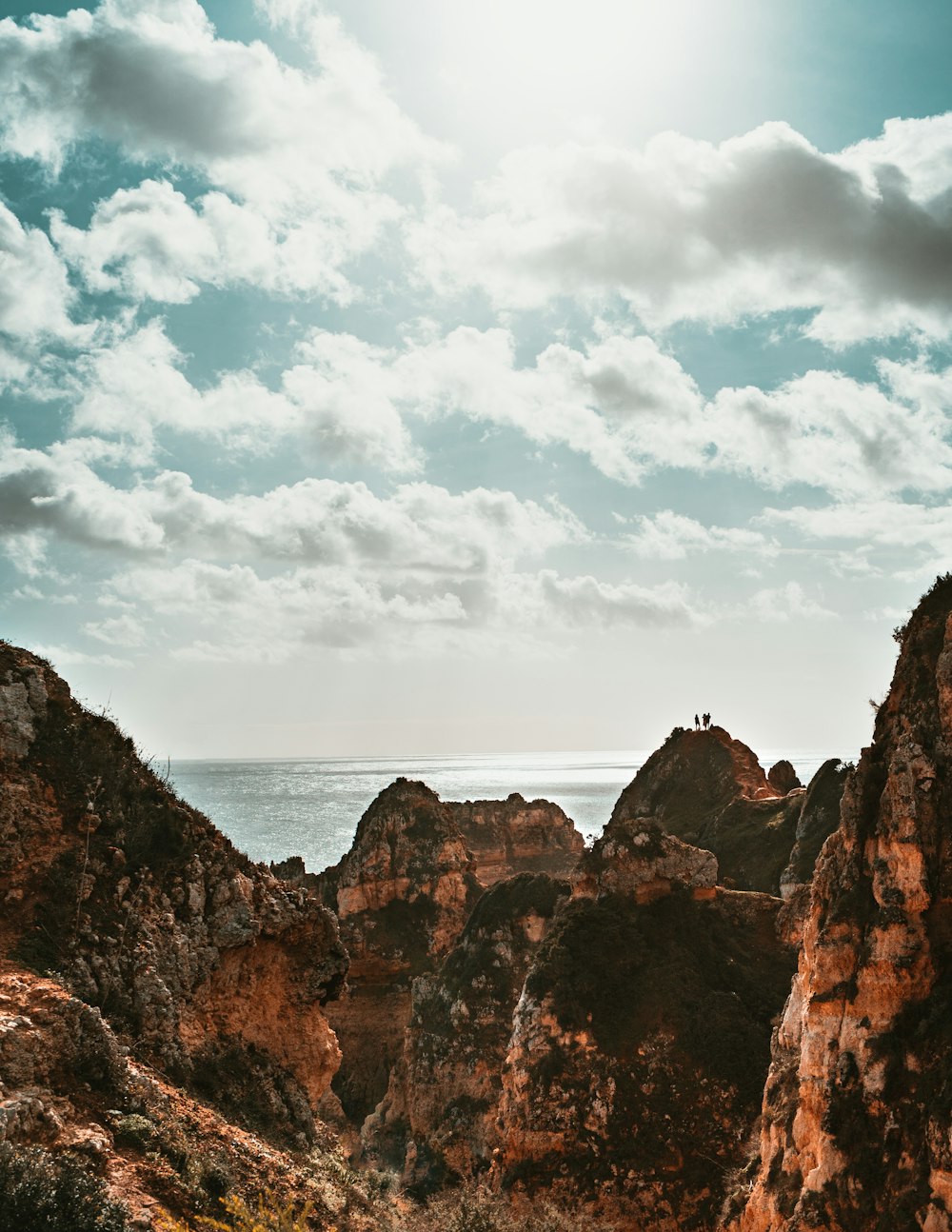 brown rock formation near body of water during daytime