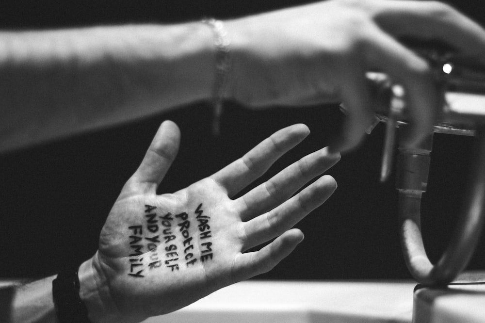 a person's hand with a tattoo on it