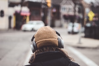 person in brown knit cap and black jacket with brown knit cap