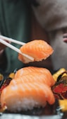 Close-up of a beautifully arranged sushi platter with vibrant salmon and avocado slices.