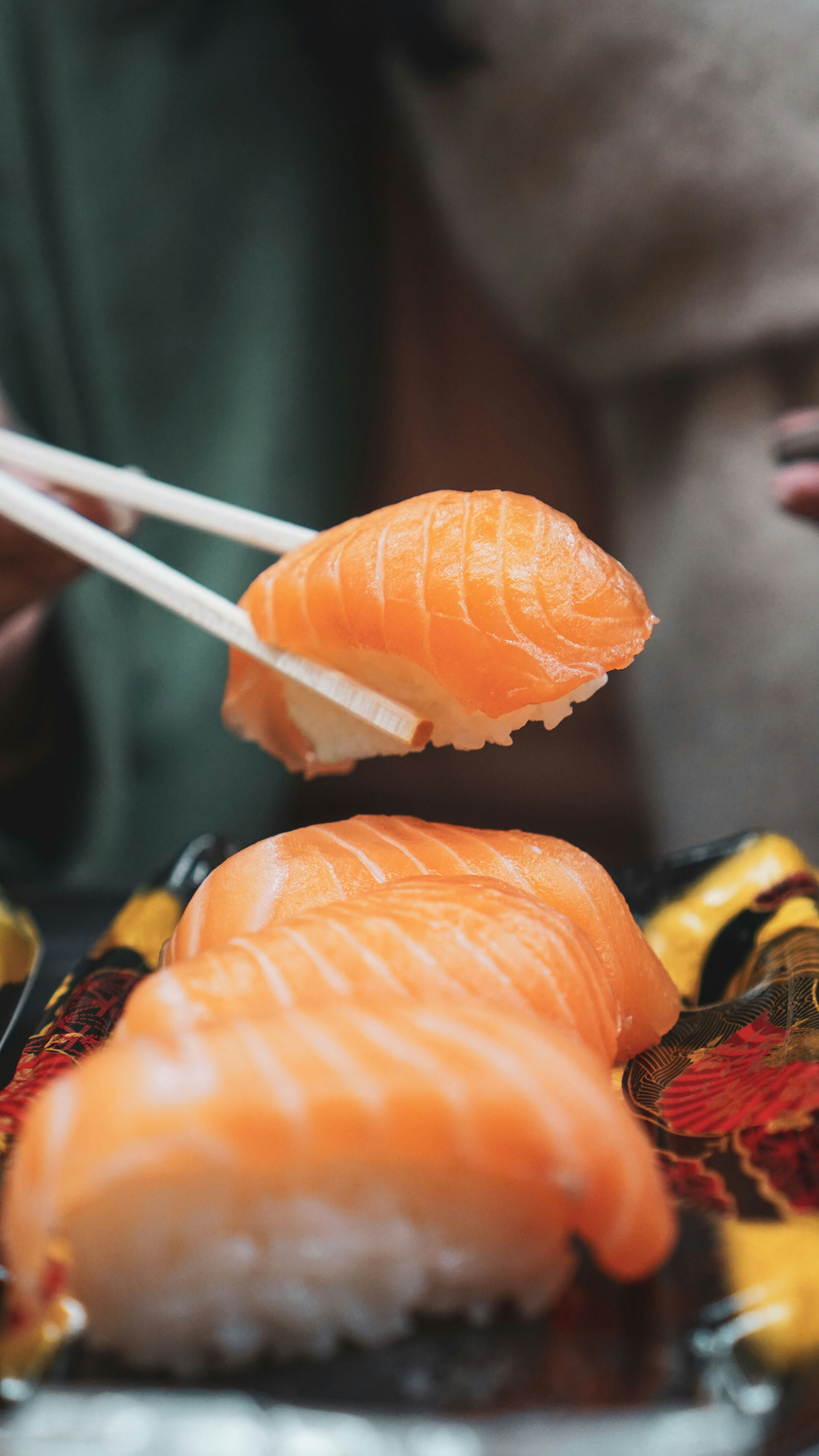 great photo recipe,how to photograph sashimi sushi in kuramon market osaka japan; orange and white carrot on black surface