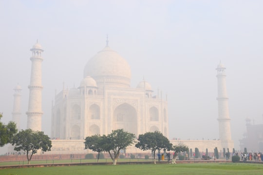 people walking on park near white concrete building during daytime in Taj Mahal India