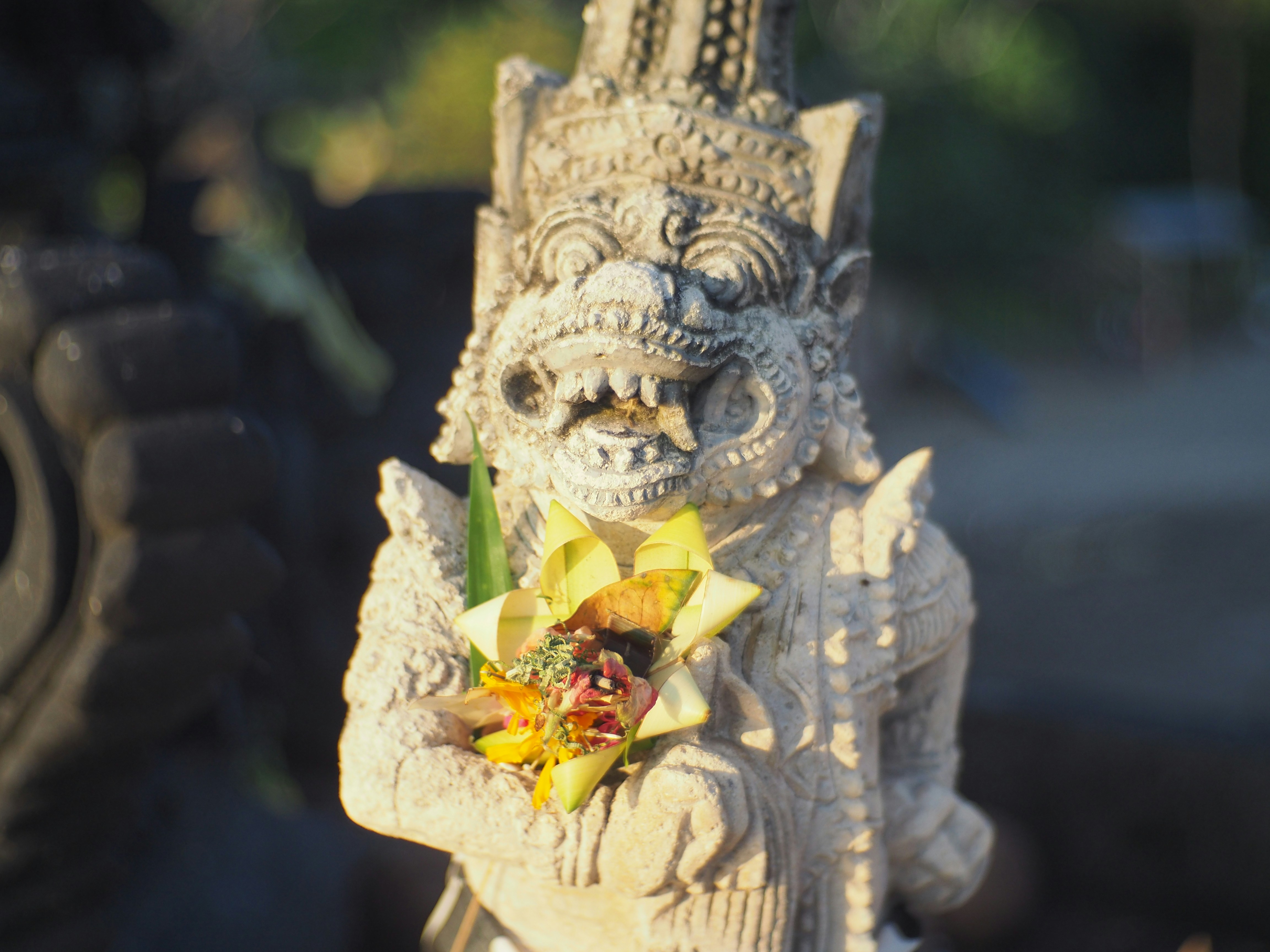 gold dragon with yellow flower on top of it