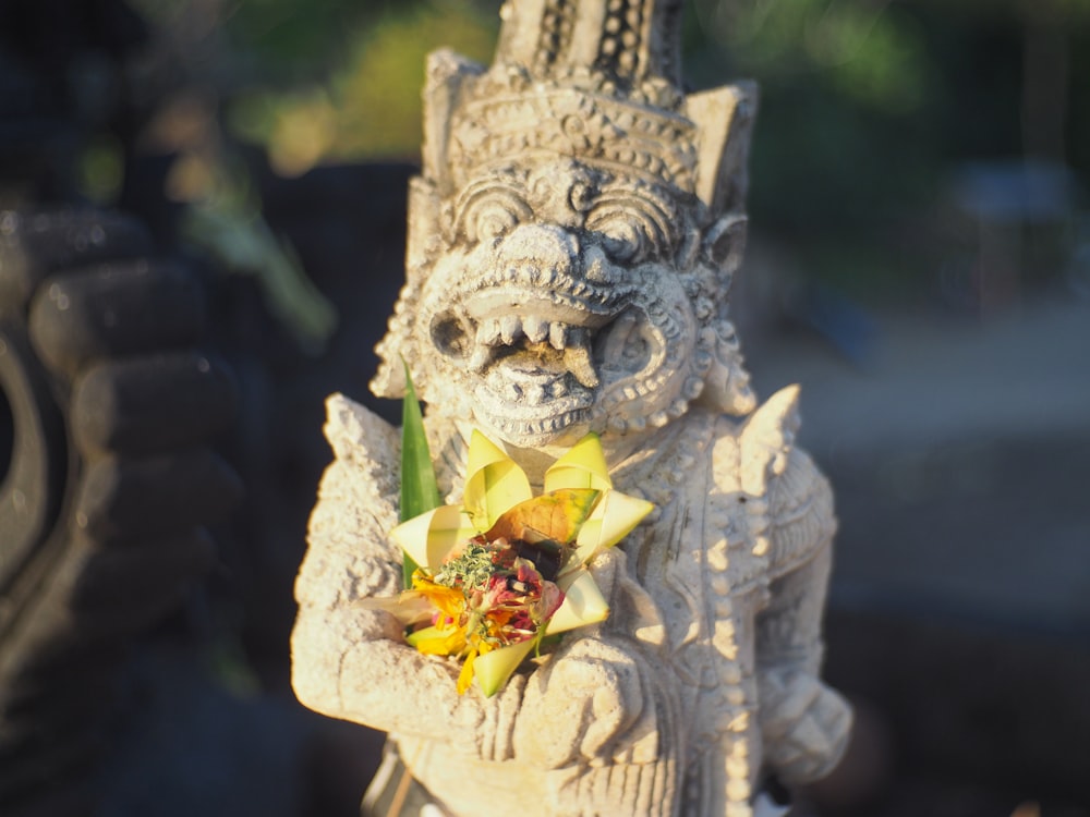 gold dragon with yellow flower on top of it