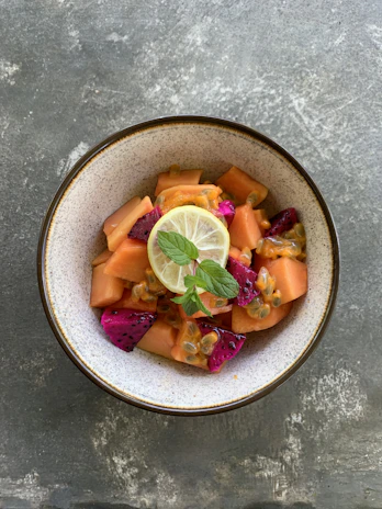 Refreshing tropical fruit salad served on a bright ceramic plate