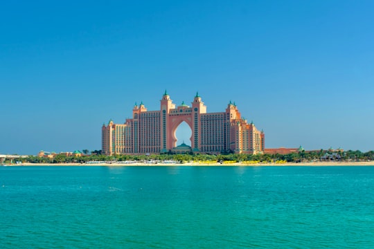 white concrete building near body of water during daytime in Atlantis, The Palm United Arab Emirates