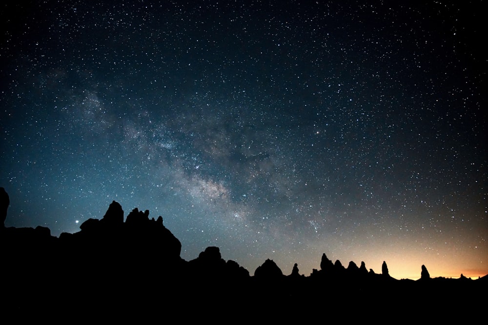 silhouette of mountain under blue sky during night time