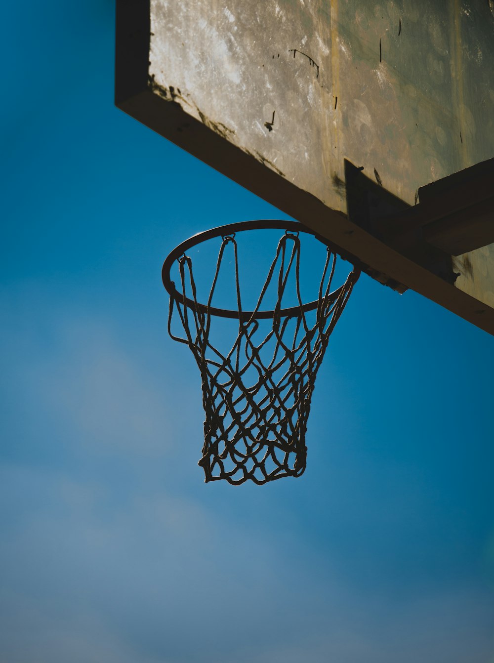 white and black basketball hoop under blue sky during daytime