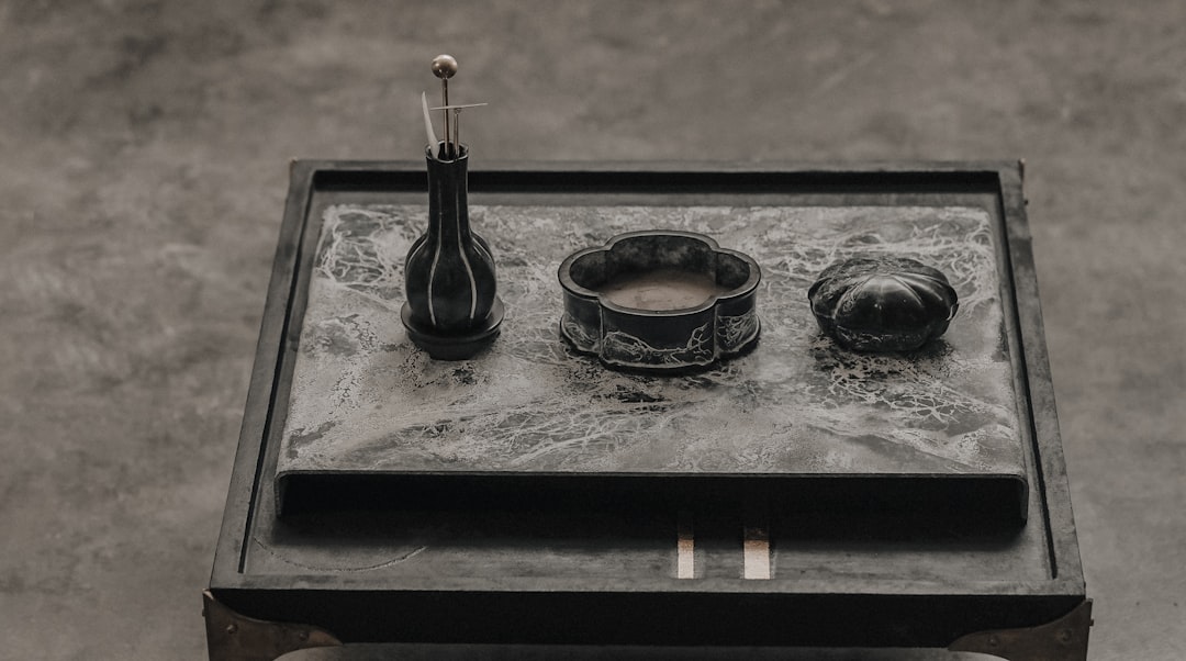 black and silver tea set on black tray