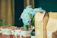 Elegant wedding gift basket wrapped in gold ribbon with fresh flowers.