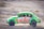 green and red car on brown field