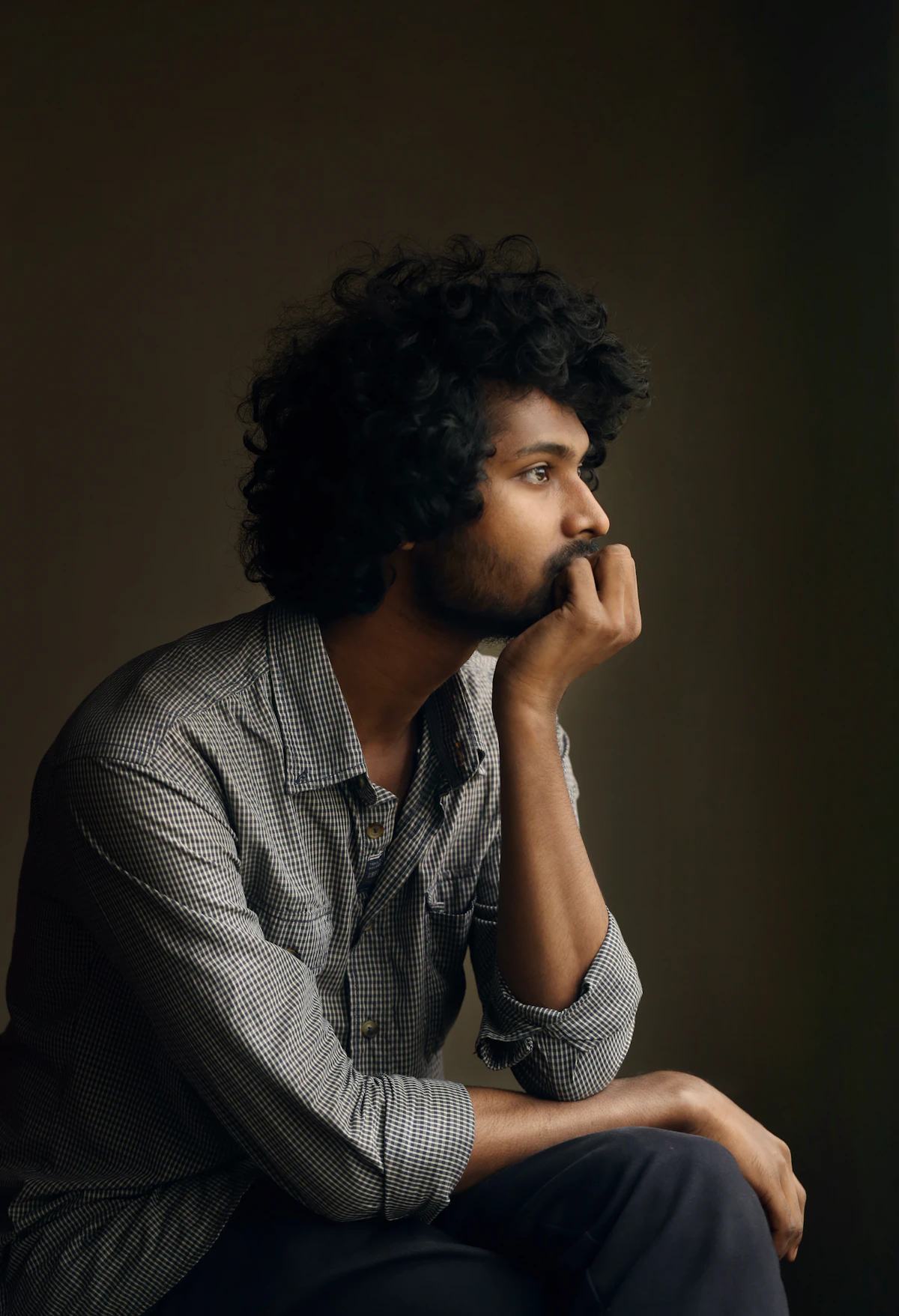 Man with a thoughtful, pensive expression, reflecting on how regular marijuana use may be affecting his testosterone and energy.