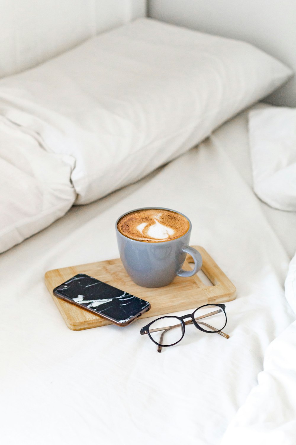 white ceramic mug on brown wooden tray