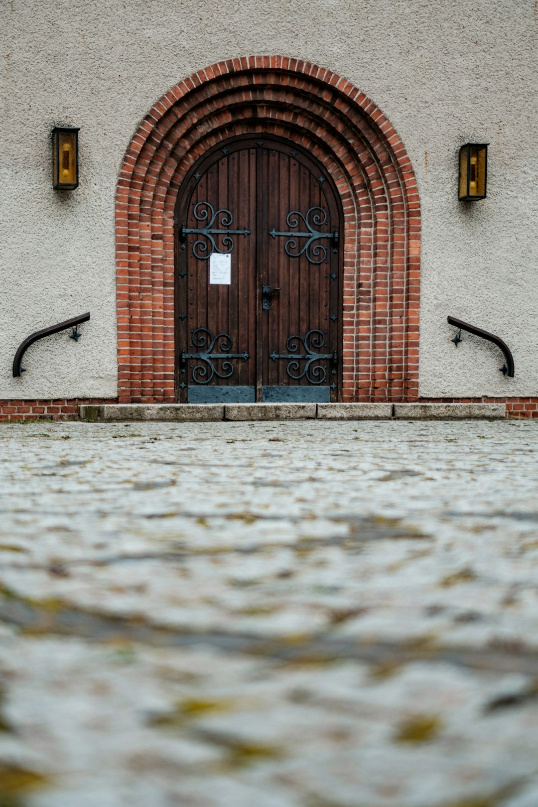brown brick building with black wooden door