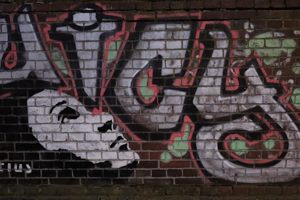 Artistic shot of Joel La Clave’s graffiti-inspired logo painted on a brick wall