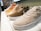 A close-up of various rubber shoes displayed on a wooden surface.