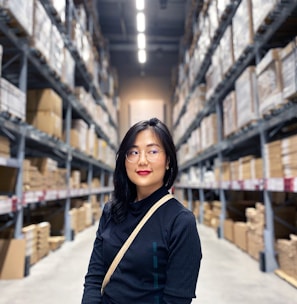 woman in black long sleeve shirt standing near brown wooden shelf