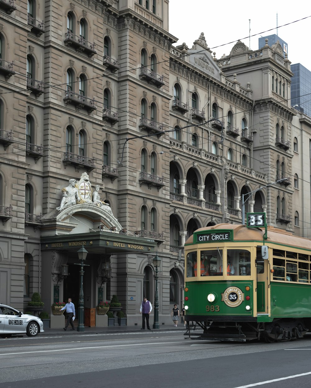 yellow and white tram on road near building during daytime