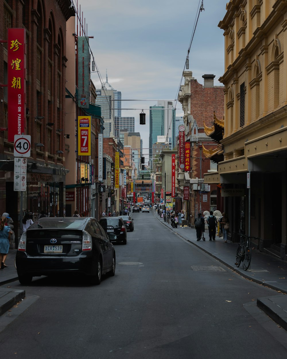 black car on road near buildings during daytime