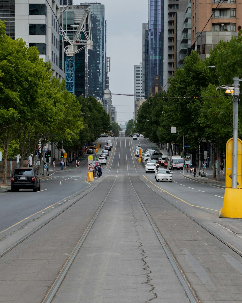 cars on road near high rise buildings during daytime