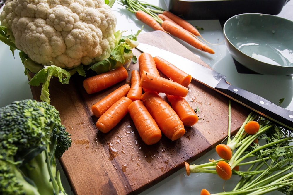 carrots and broccoli on brown wooden chopping board