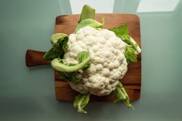 white cauliflower on brown wooden chopping board