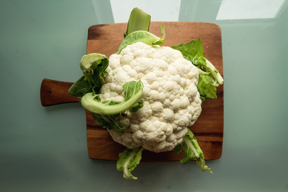 white cauliflower on brown wooden chopping board