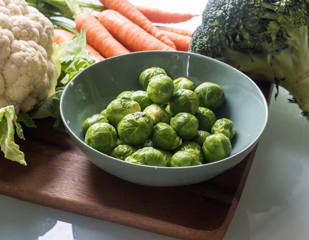 green round fruit on green ceramic bowl