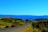 A scenic view of a winding road through green hills.
