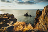 A serene coastal cliffside at sunset, perfect for dramatic scenes.
