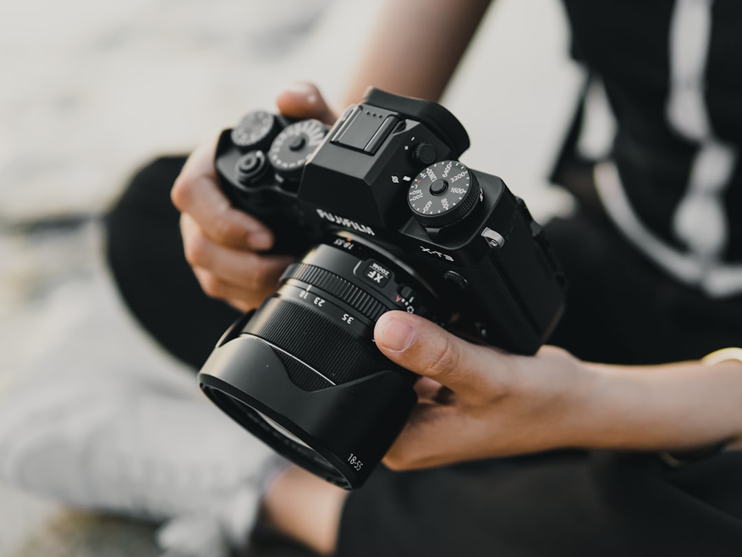 person holding black nikon dslr camera