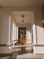 Sunlit hallway with seamless, flawless custom flooring that reflects timeless style.