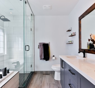 A bright open bathroom with a glass walk in shower