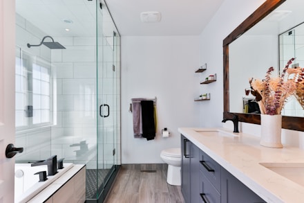 A bright open bathroom with a glass walk in shower