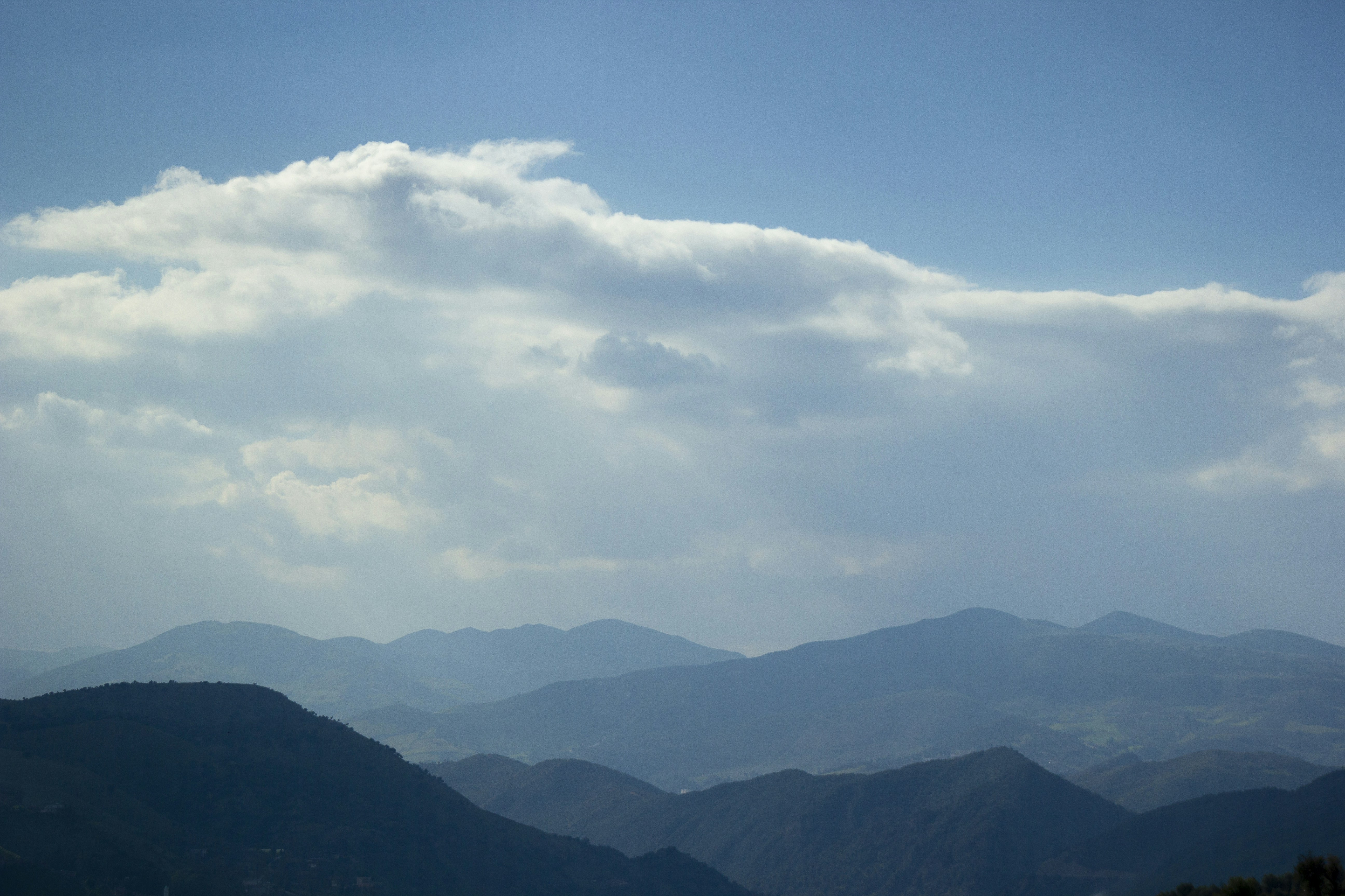 mountains under white clouds and blue sky during daytime algeria teams background