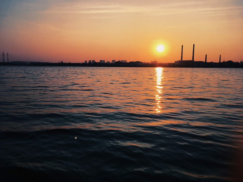 body of water during sunset