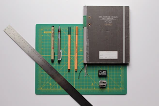 black covered book with pencils and pencils