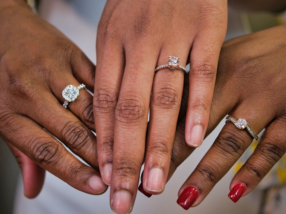 person wearing silver diamond ring