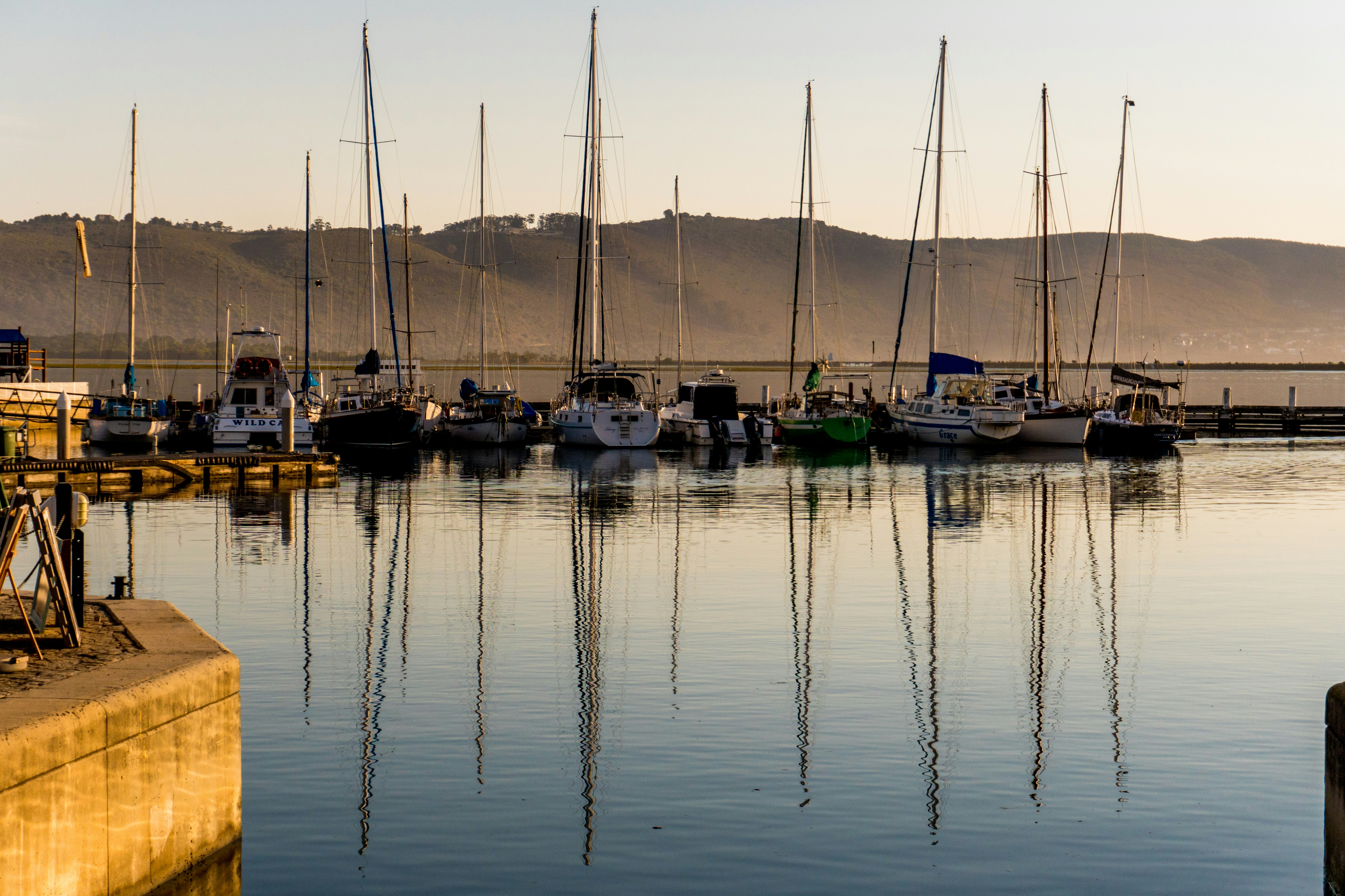 white and blue boat on body of water during daytime