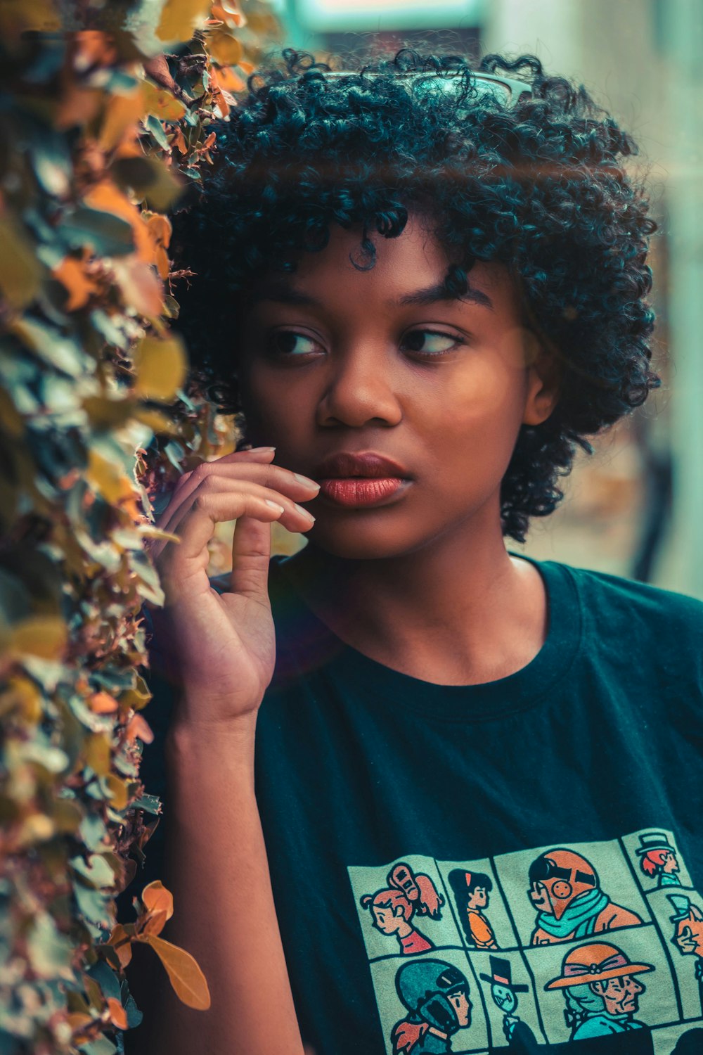 woman in blue crew neck shirt holding yellow flowers