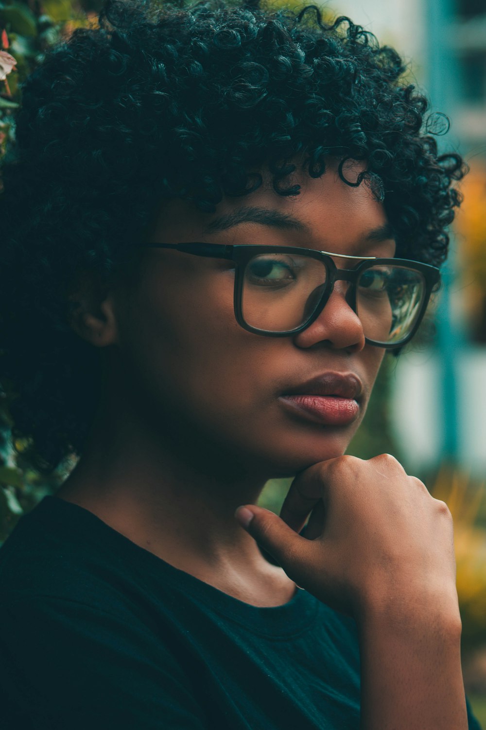 woman in black crew neck shirt wearing black framed eyeglasses