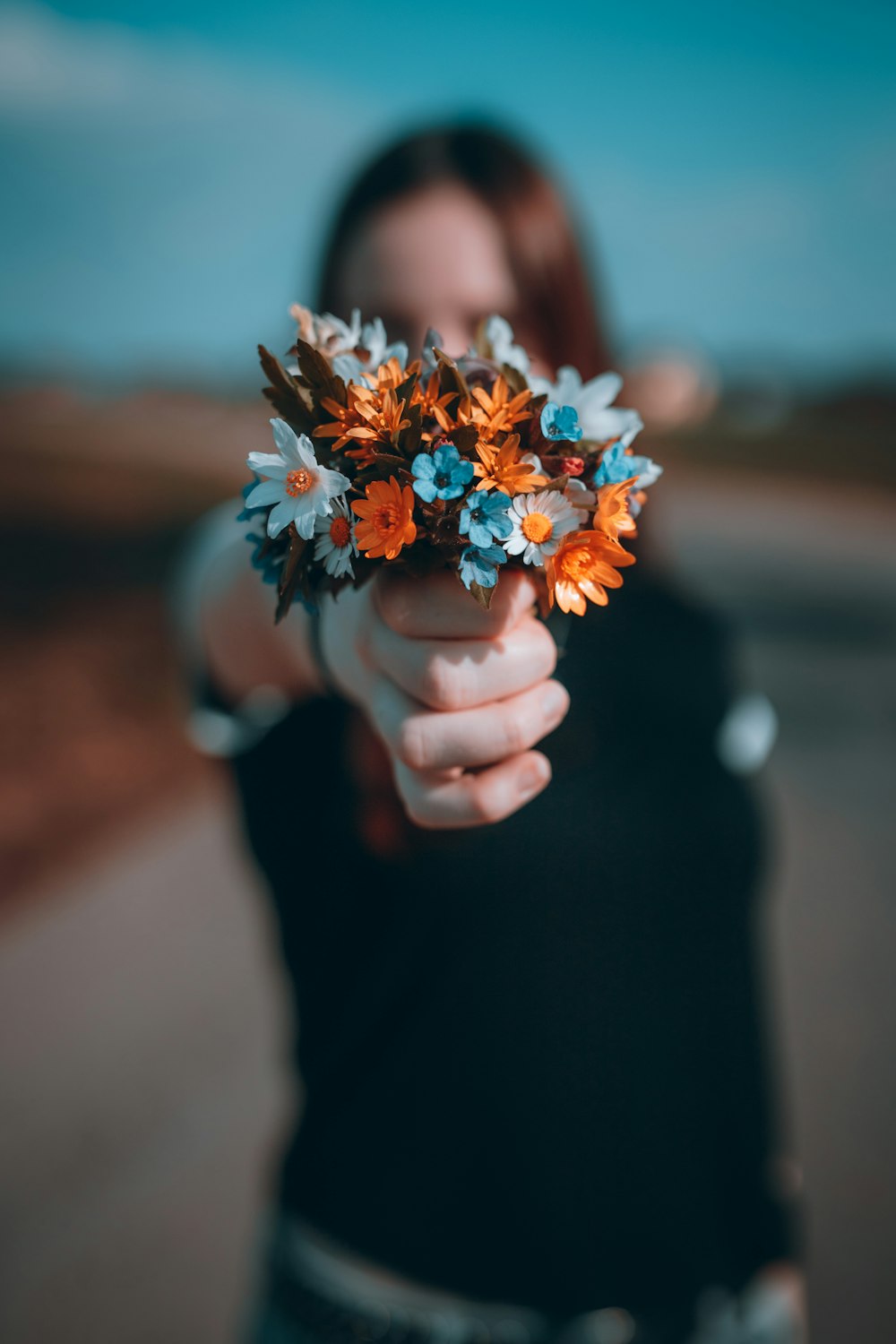 person holding yellow and white flower