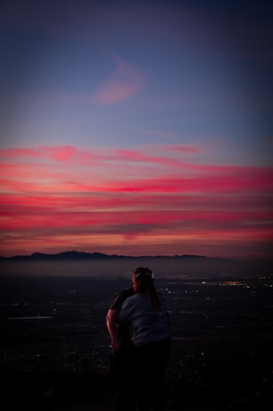 Sunset over Andes mountains with a couple admiring the view
