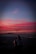 A couple enjoying a sunset view at a popular travel destination.