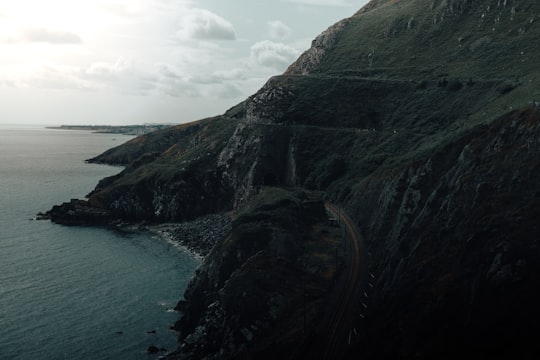 green and brown mountain beside body of water during daytime in Bray Head Ireland