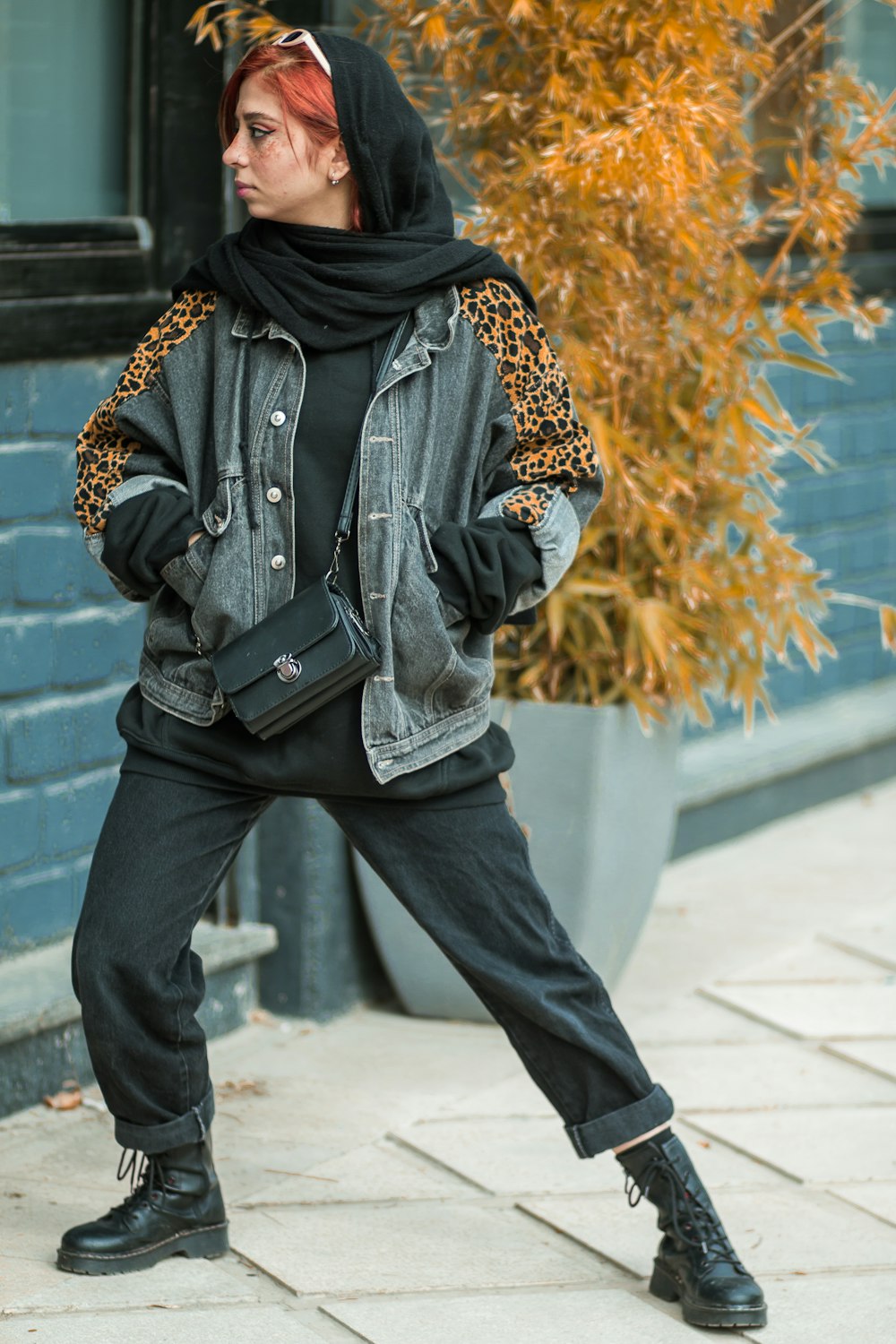 woman in black and brown hijab and black leather sling bag