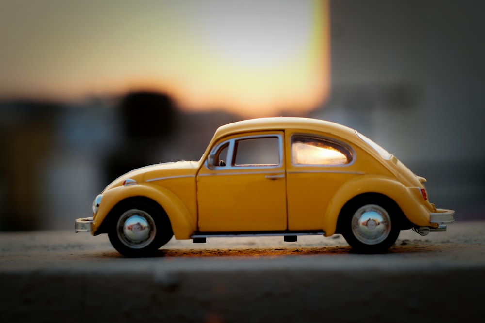 yellow volkswagen beetle on road during daytime