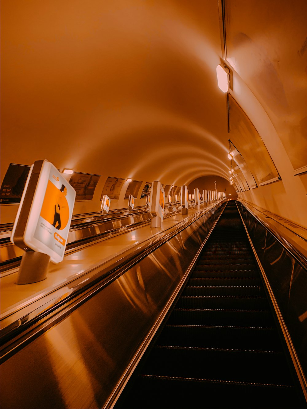 white and black escalator in a building