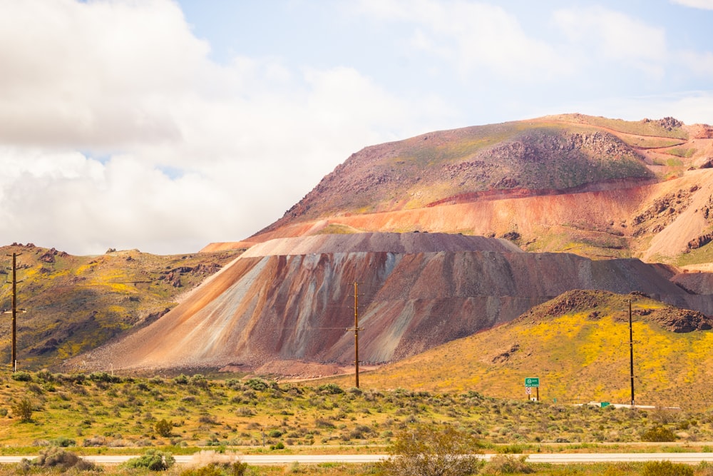 brown mountain under white clouds during daytime