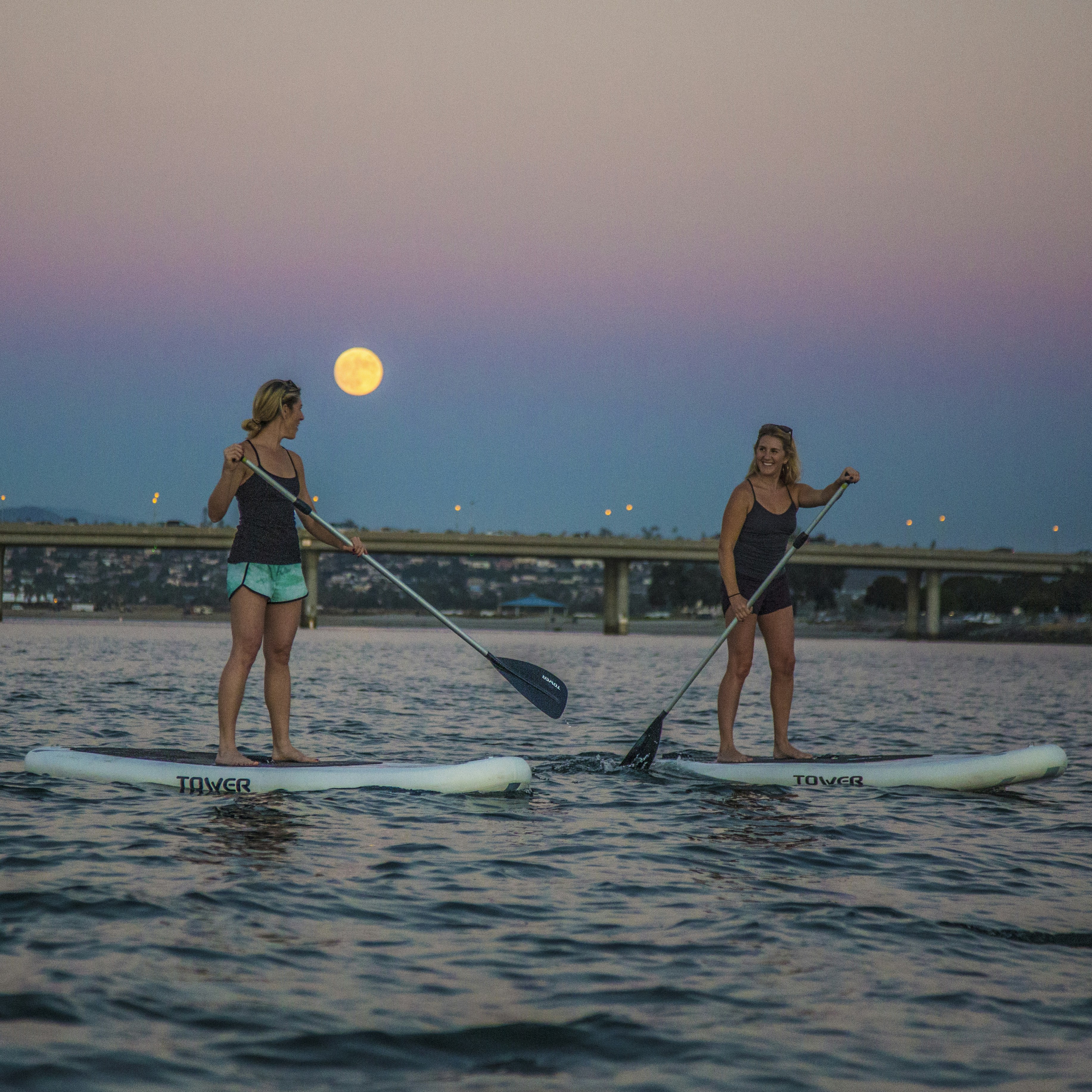 Paddleboarding under the moon.